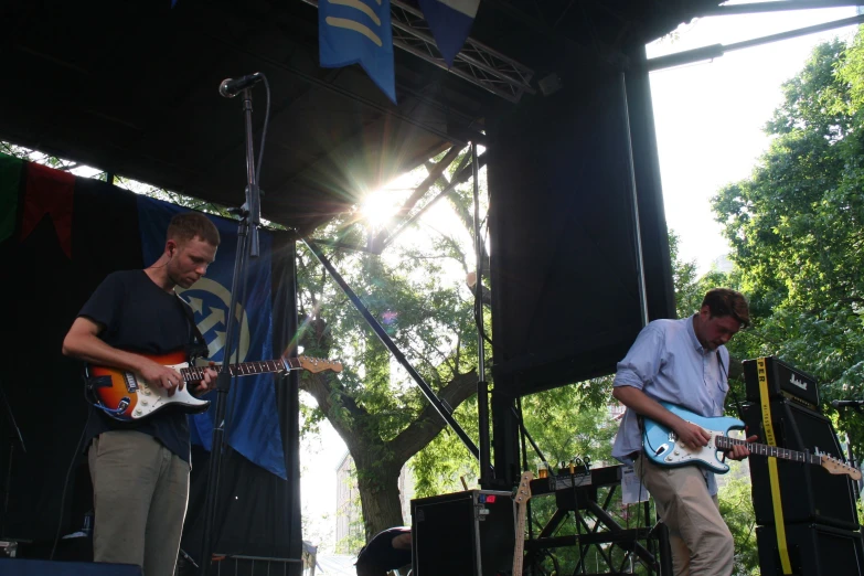 two men playing music on stage at an event