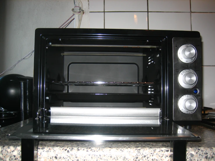 a black toaster oven sitting on top of a counter