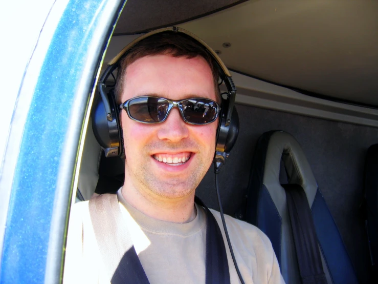 a man with headphones, on a sunny day