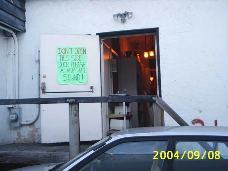 a white vehicle sitting in front of a closed up business