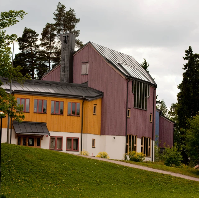 there are a few cars parked outside of this colorful house