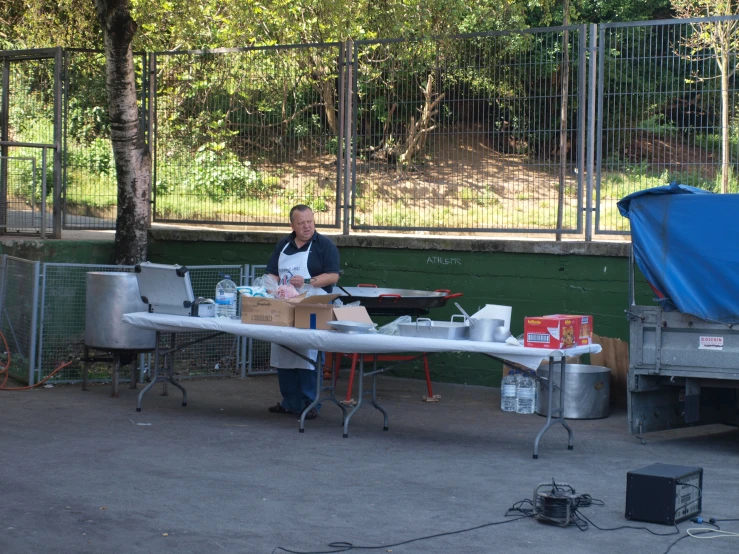 a man with a box sitting at a small table