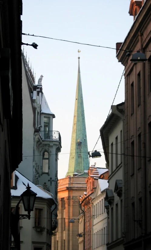 an old town street with old buildings and steeple