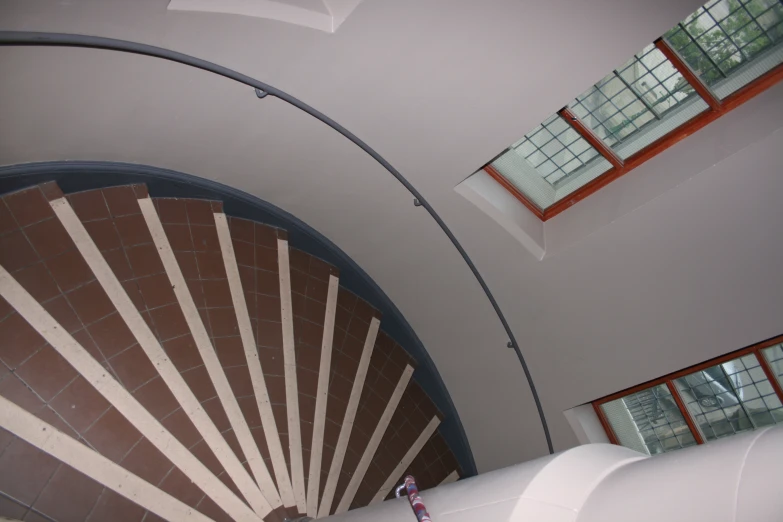 a spirally shaped staircase leads to two windows