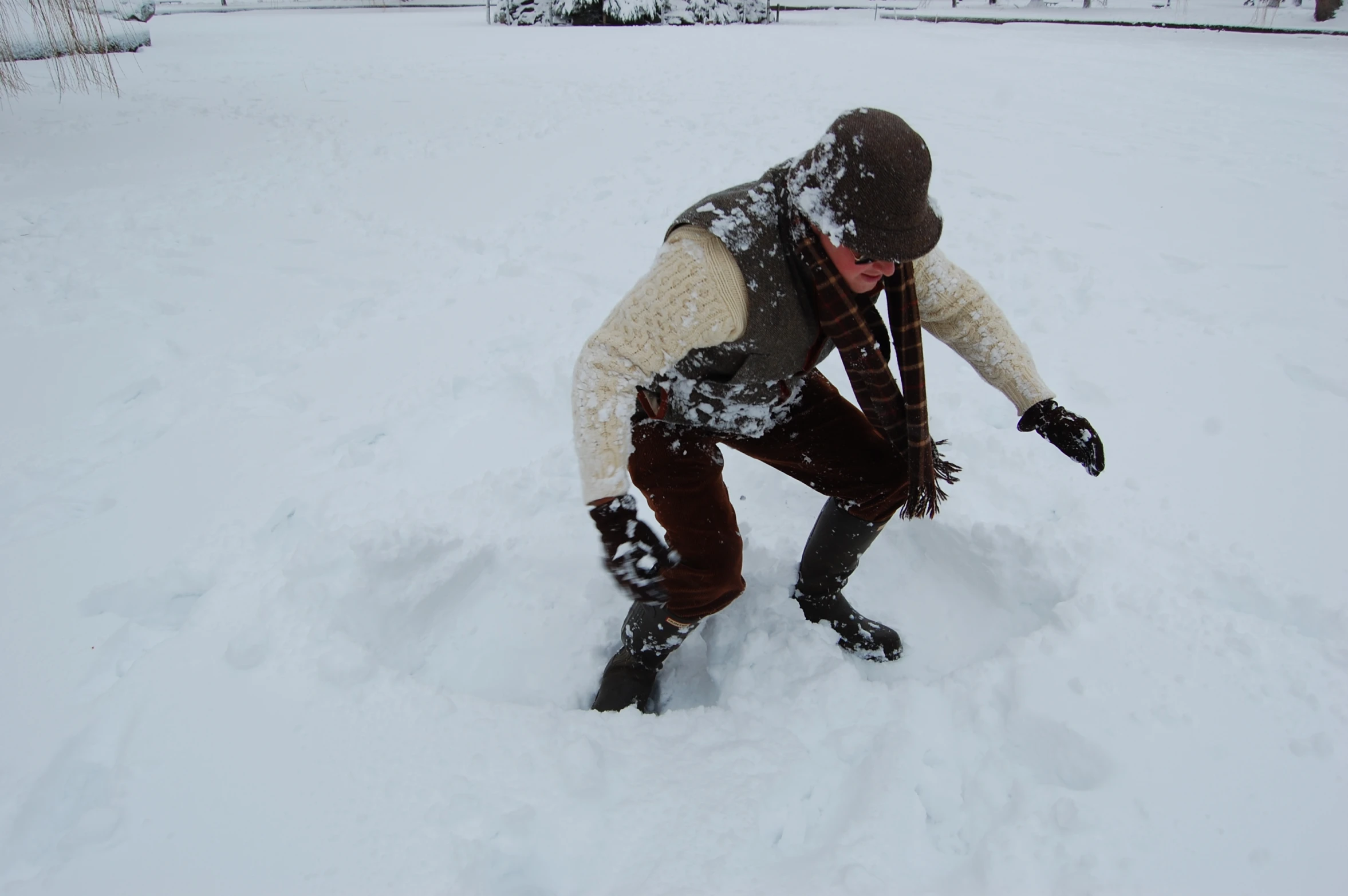 there is a person kneeling down in the snow