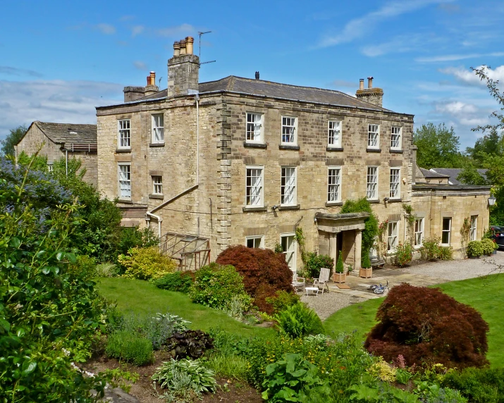 an image of a large mansion in the middle of the green