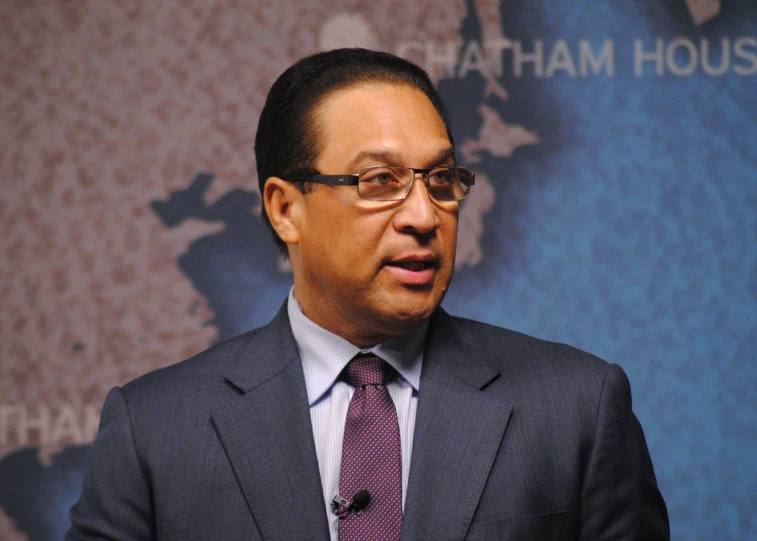 a man in suit and tie speaking to an audience