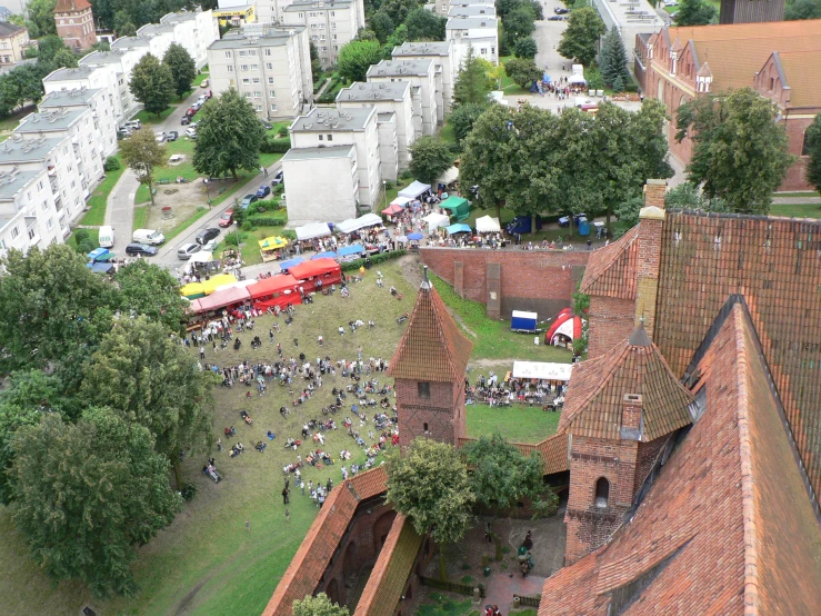 a city skyline with large buildings, tents and a field