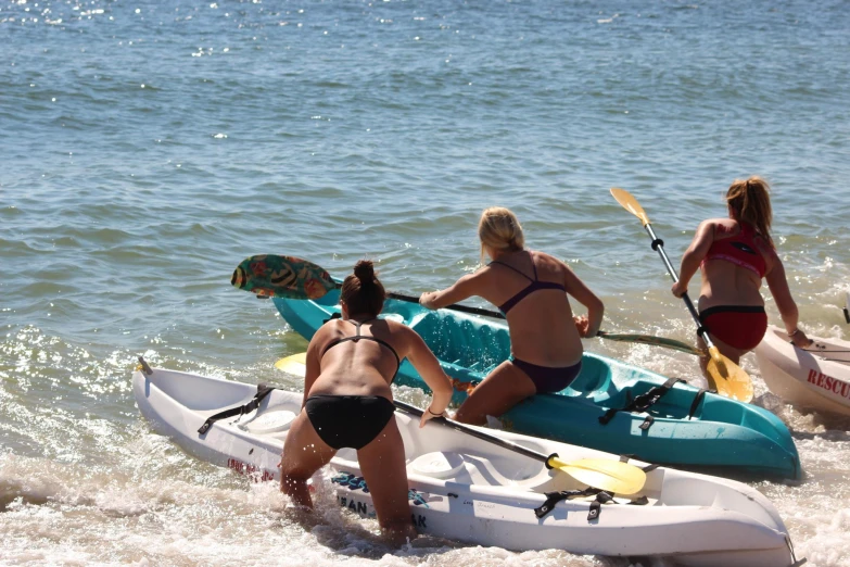 a group of people riding kayaks in the ocean