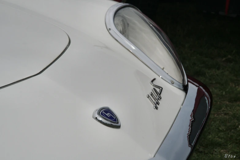 an old style car with badges and tail lights