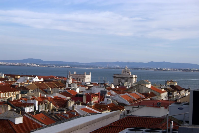 several buildings in the foreground and an ocean behind them