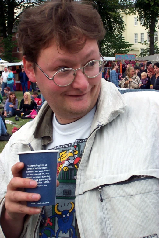 a man that is holding up a book