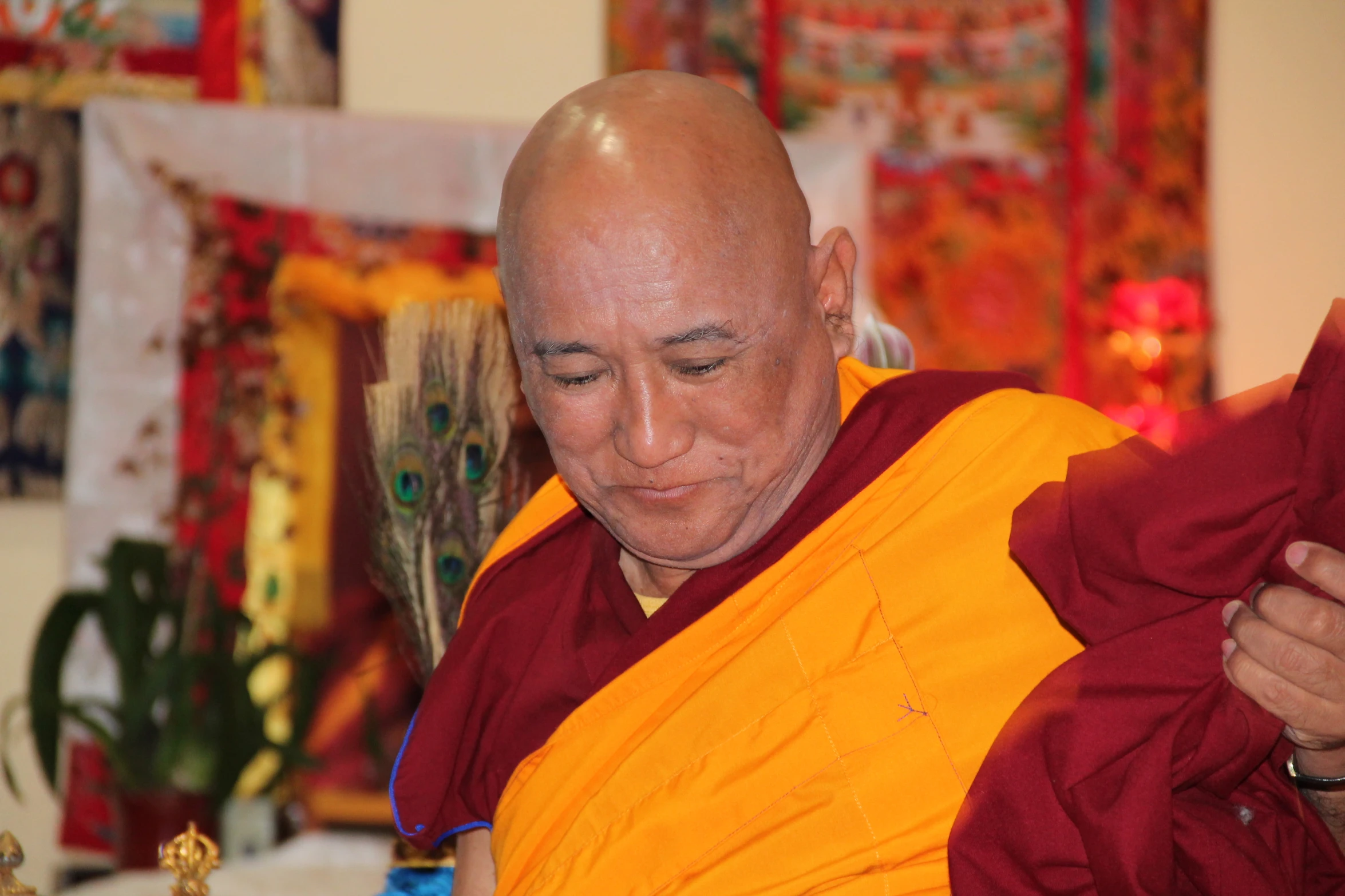 an old man smiling and talking to a monk