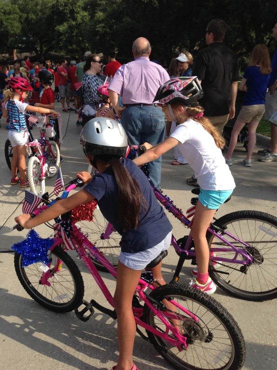 a couple of girls are sitting on bicycles