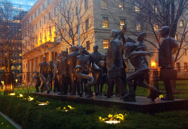 a statue of people outside in the night