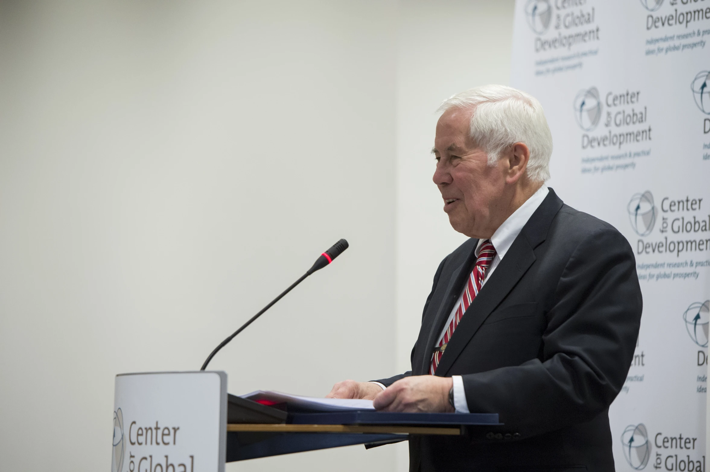 an older man speaking at a podium