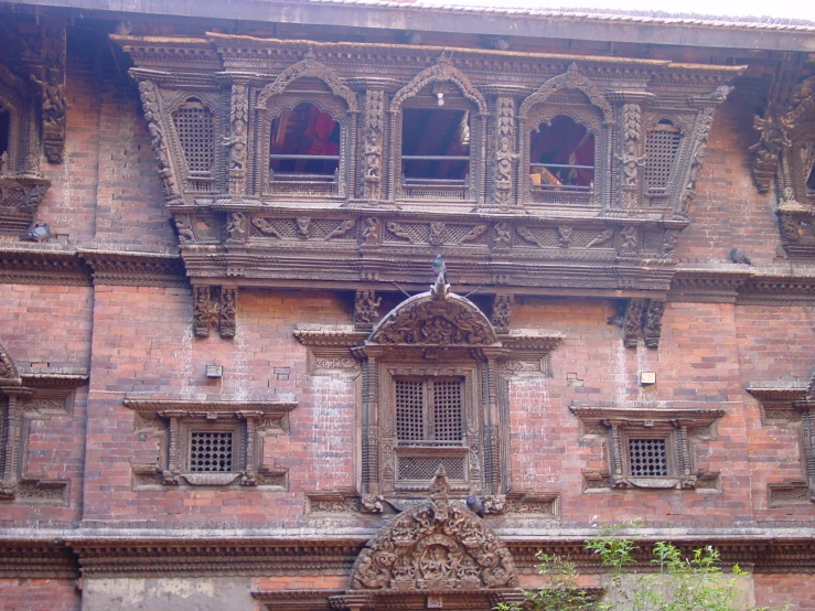 an ornate building with people looking out from windows