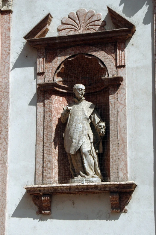 a statue in front of a wall