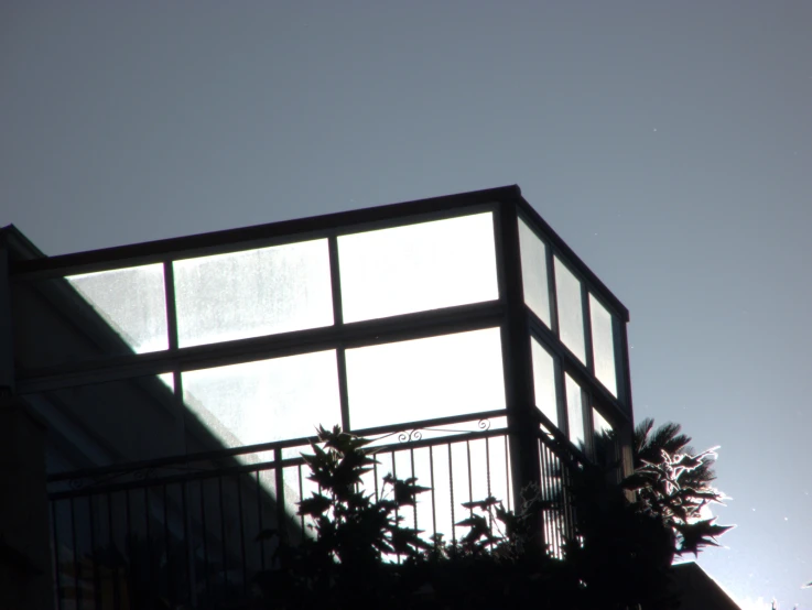 a building with multiple glass and metal balconies