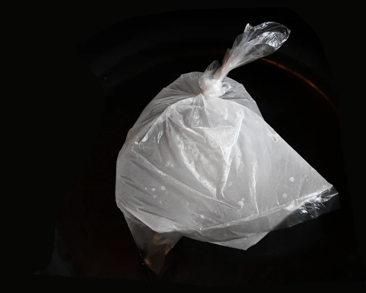 a plastic bag that is sitting on top of a black table