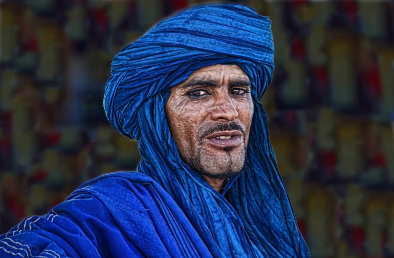 a portrait po of a man in a blue turban