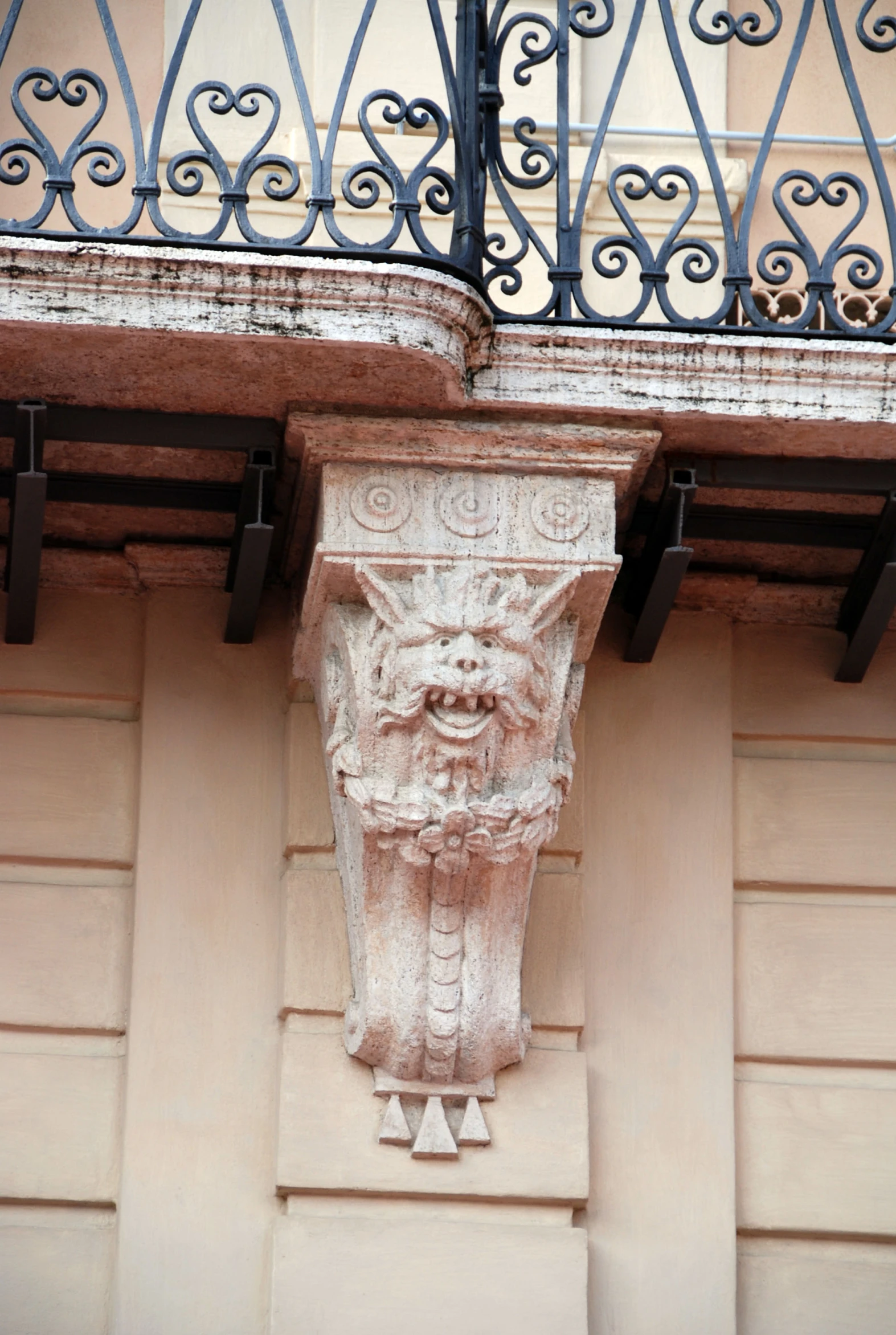 a sculpture on a wall has ornamental ironwork