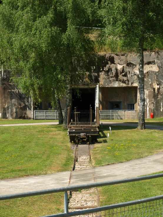 a train going through an open tunnel in a park