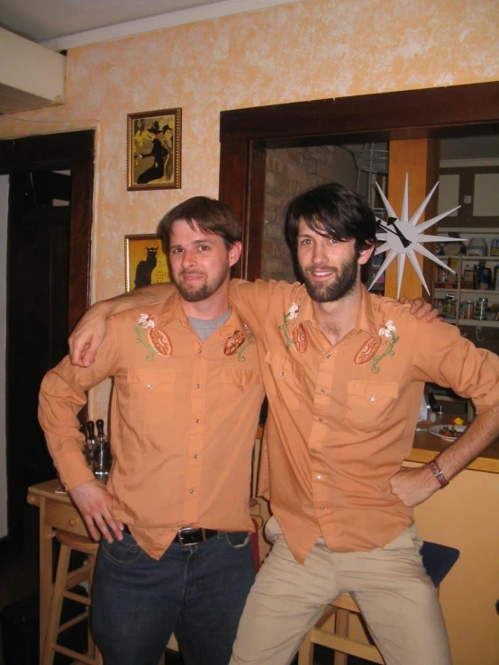 two men in brown shirts with a star