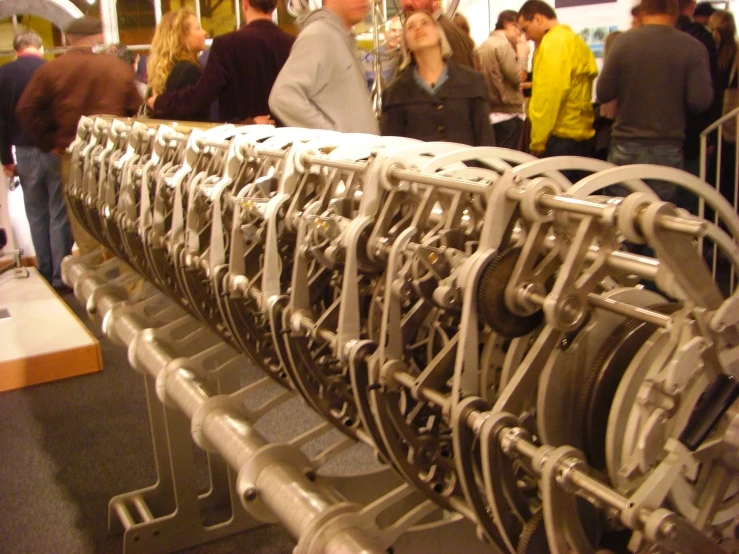 a large row of silver pipes sitting in the middle of a room