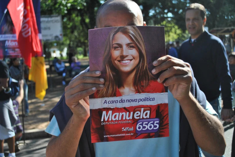 there is a man that is holding a newspaper in his hands