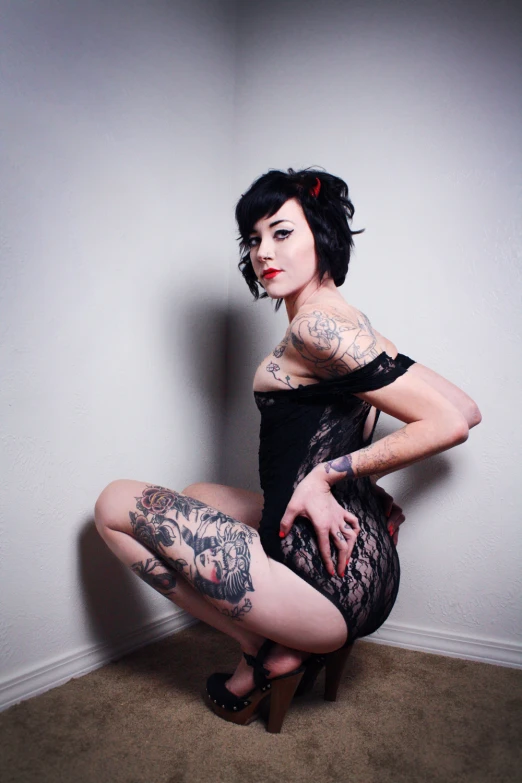 a girl in an open dress and boots with tattoos