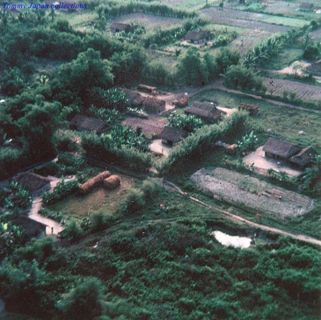 a house and small village on an aerial view