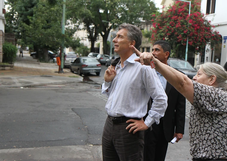 a woman is pointing at the man in the tie