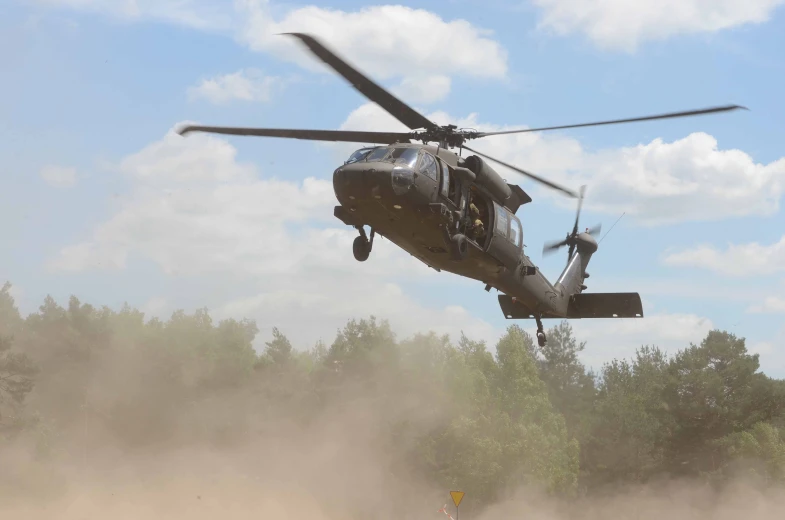 a helicopter flying in the air and taking off