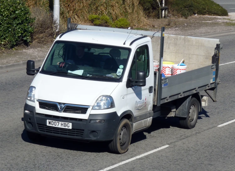 a white delivery truck on a city street