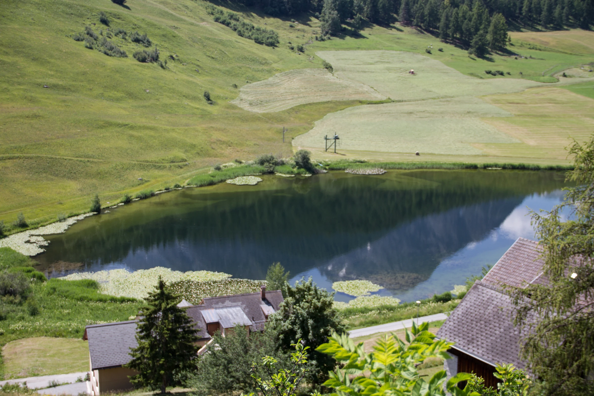 a small pond near the side of a mountain