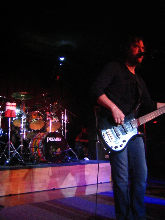 a man is playing the guitar on stage