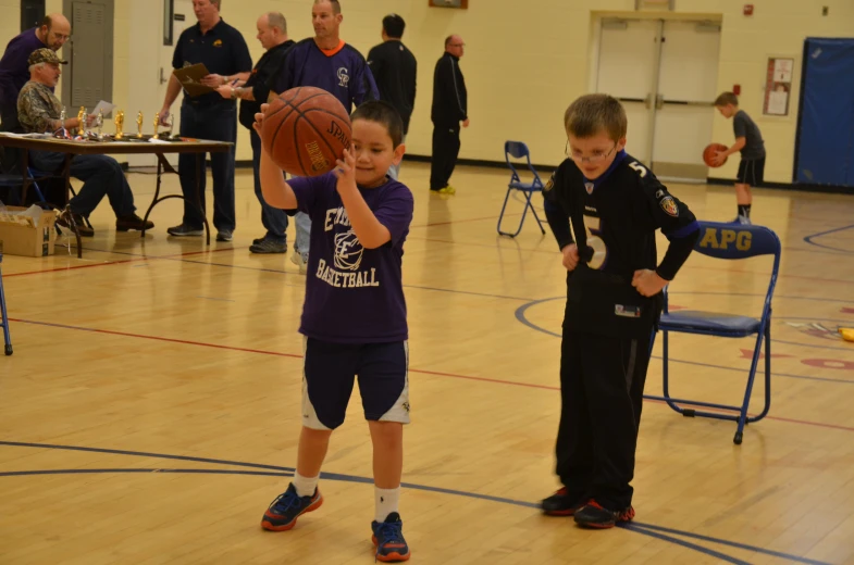 two s are holding a basketball in their hands