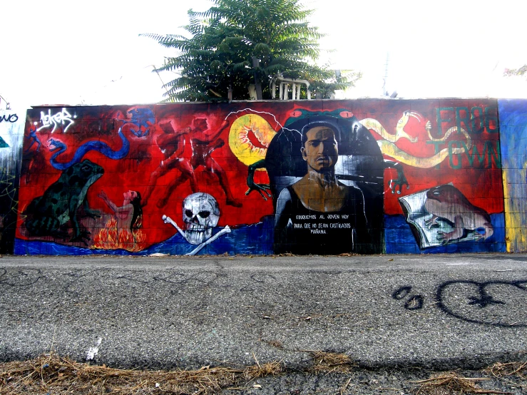 the skateboard is parked on the curb with graffiti