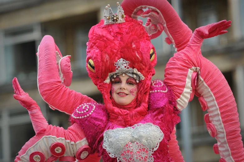 a woman in pink is riding an elephant costume