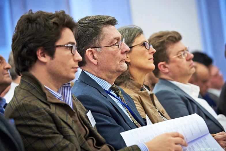 a group of people sitting down in rows