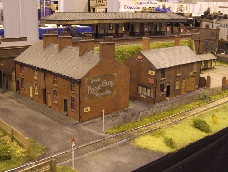 a model train station and some buildings on the track