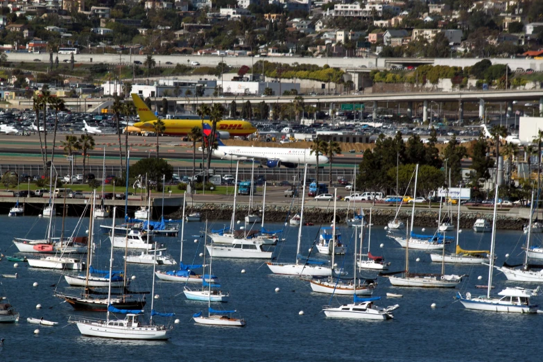 boats float along the water and sail in the distance