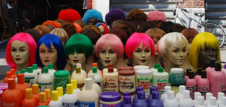 a lot of wigs of different colored bottles and bottles of hair