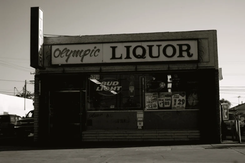 the front of a liquor store in black and white