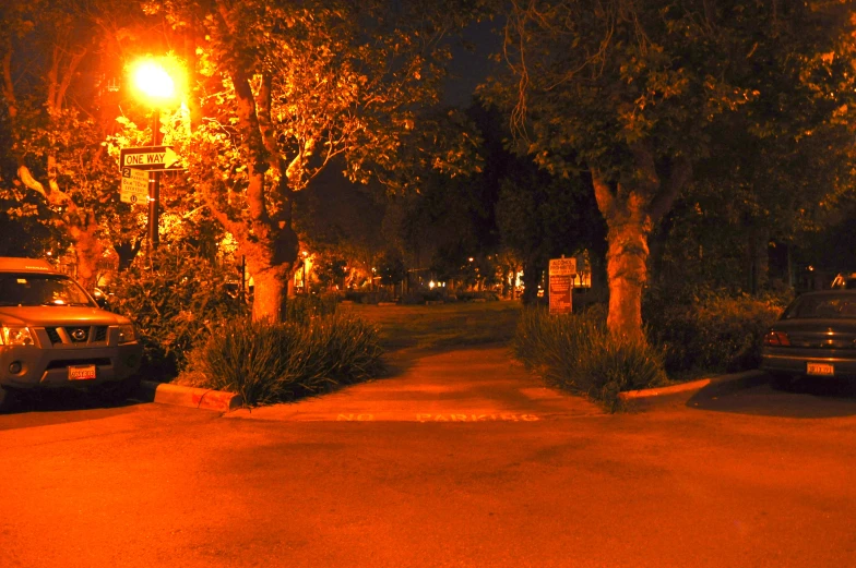 an empty road at night lit up by street lights