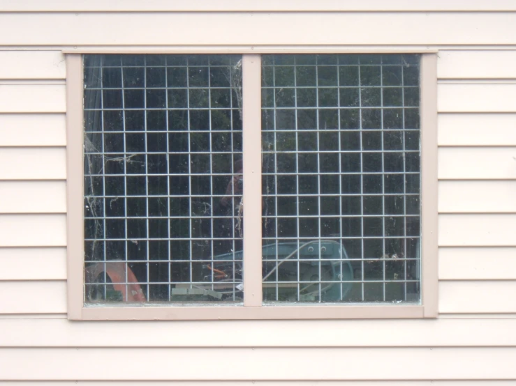a window with a glass grille that is behind the curtain