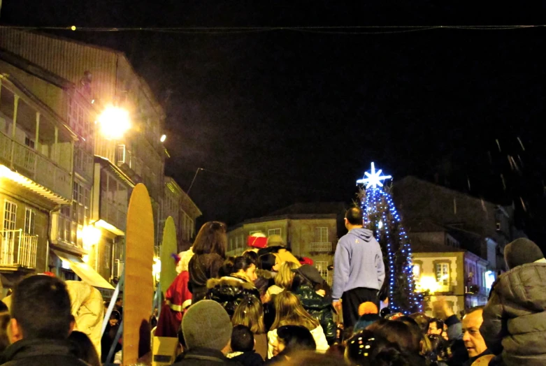 a group of people standing around a tree