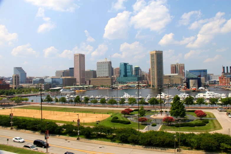 a group of vehicles parked by the water near some buildings