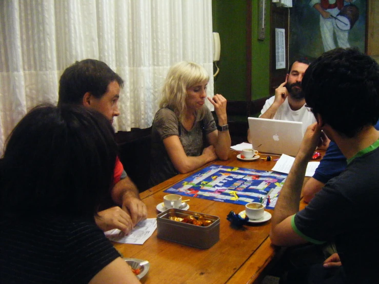 a group of people at a table eating pizza